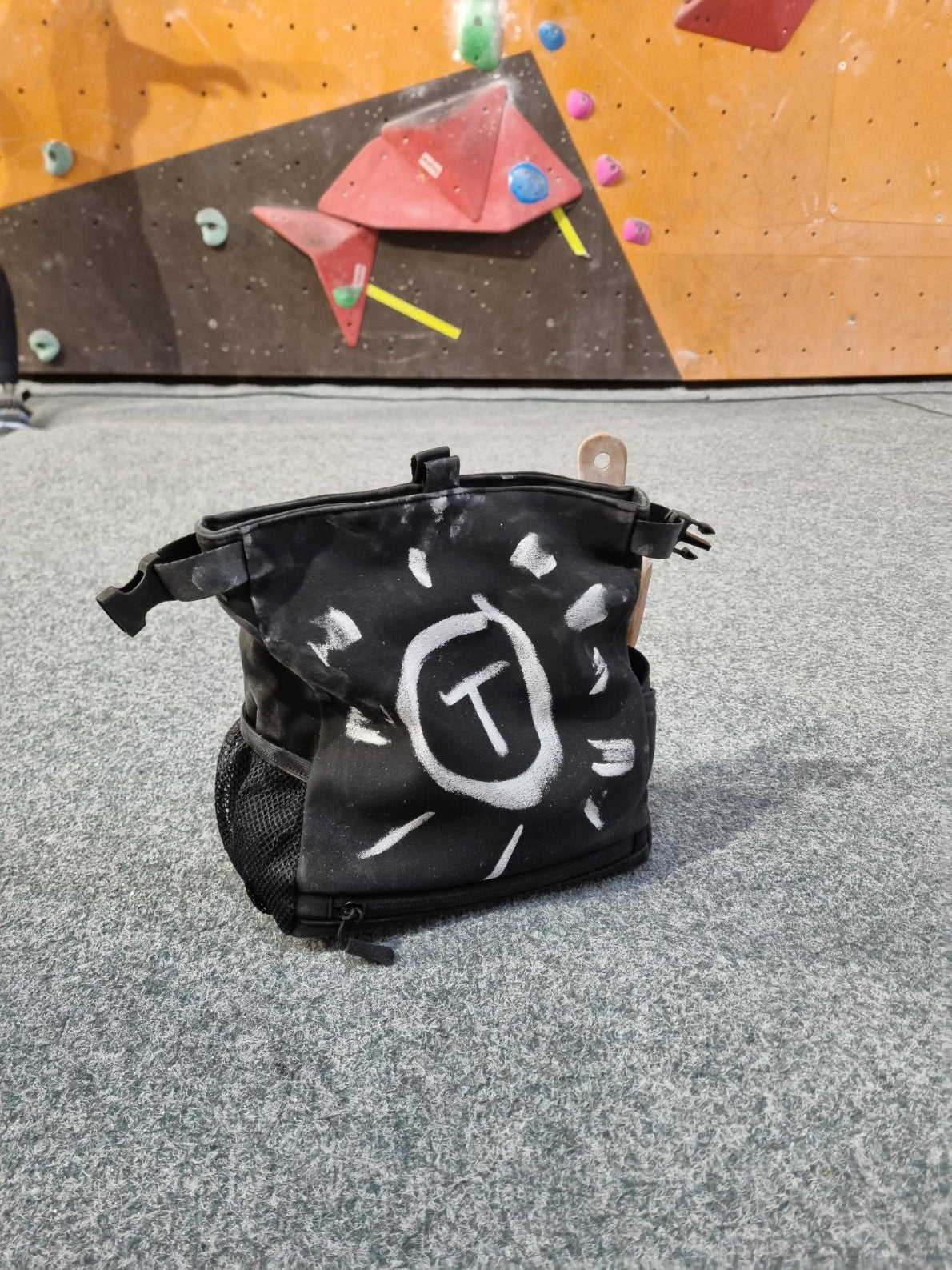 Close-up of chalk drawings left by friends on a MAG BAG
